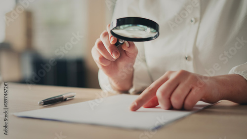 Tableau sur toile Examining documents with a magnifying glass