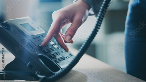 A Businesswoman's Hand Calling On Landline