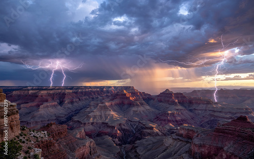 Dramatic Lightning Strike over the Grand Canyon National Park during Stormy Sunset with Golden Hour Light for Adventure Travel and Nature Power