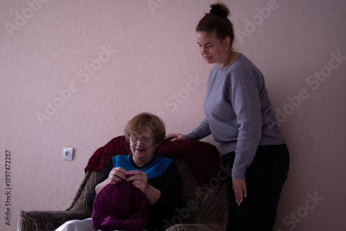 Elderly woman knitting in a chair