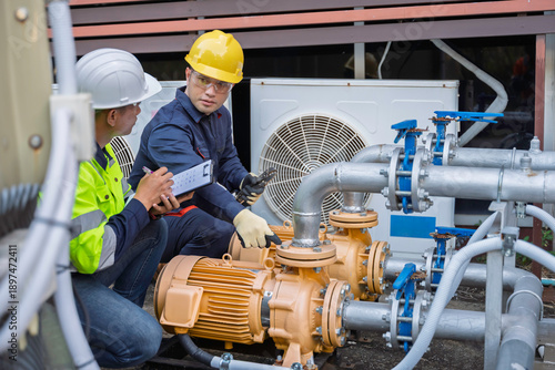Cuadro en lienzo Two professional engineers inspecting industrial air conditioning system outside