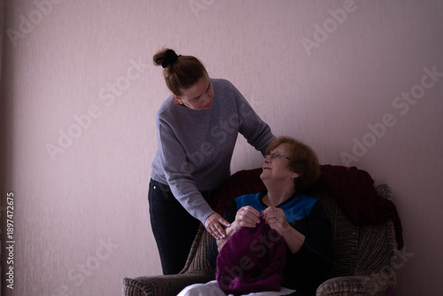 Elderly woman knitting in a chair