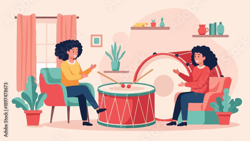 Two smiling people sit in chairs near a large drum and drumsticks in a cozy room