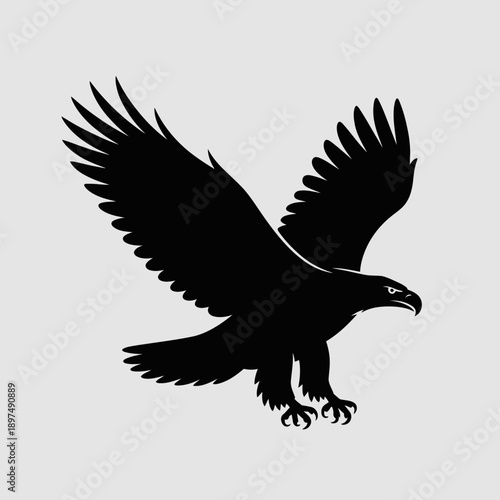 Black silhouette of a crow in flight with wings spread, landing on a gray background