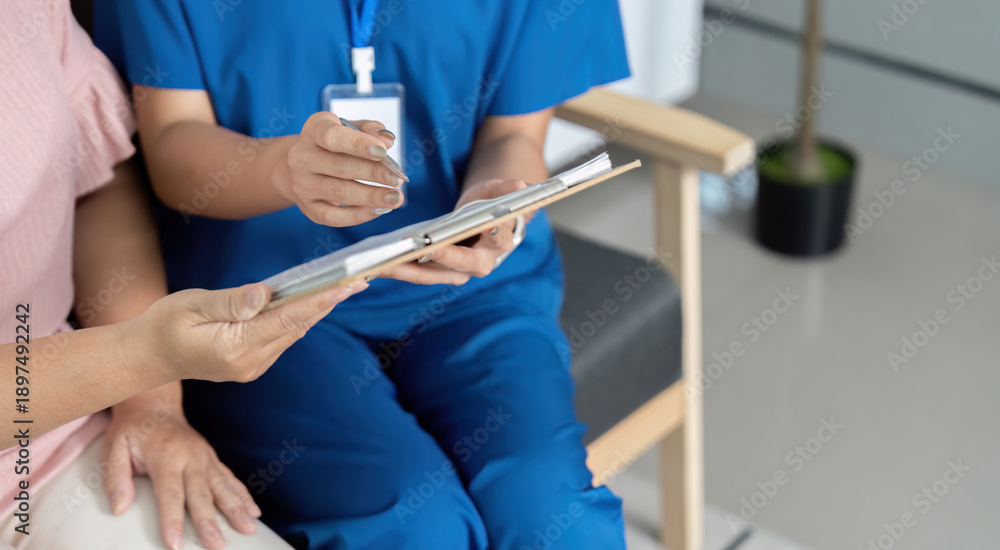 Naklejka premium A woman in a blue uniform is sitting in a chair with a clipboard in front of her