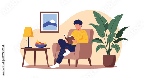Man relaxes in a comfortable armchair while reading a book in a cozy room decorated with a plant and a painting.