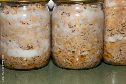 Canvastavla Glass jars with homemade canned meat filled with juicy stew and covered with a layer of white natural fat