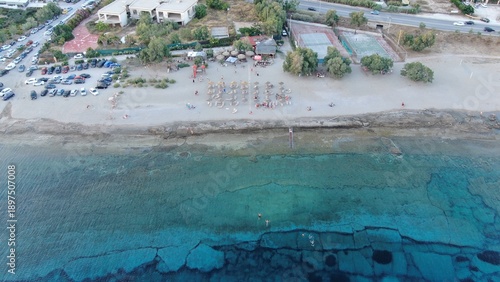 Aerial 4k view of Agios Nikolaos church on the rocky coast of Lagonisi, Greece