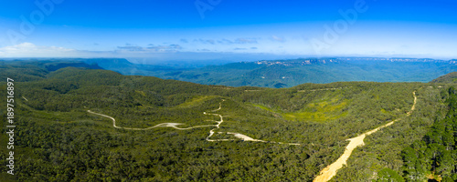 Drone aerial photograph of a dirt track running along the ridgeline of the Jamison Valley near the town of Wentworth Falls in the Blue Mountains in New South Wales, Australia.