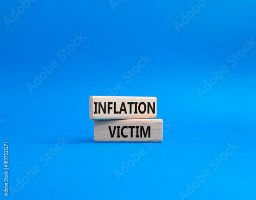 Inflation Victim symbol. Wooden blocks with words Inflation Victim. Beautiful blue background. Business and Inflation Victim concept. Copy space.
