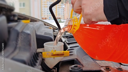 Tableau sur toile Pouring Coolant into Car Engine Reservoir