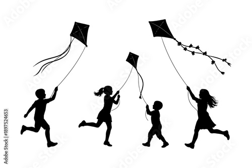 Silhouette of children flying kites outdoors.