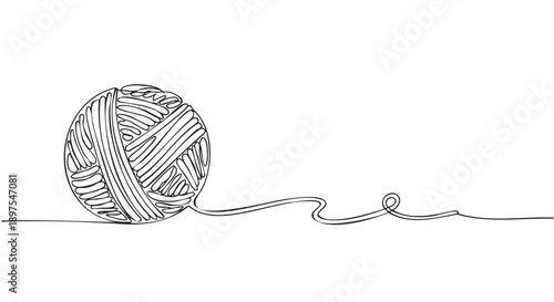 Handmade yarn ball with loose thread end and wooden crochet hook