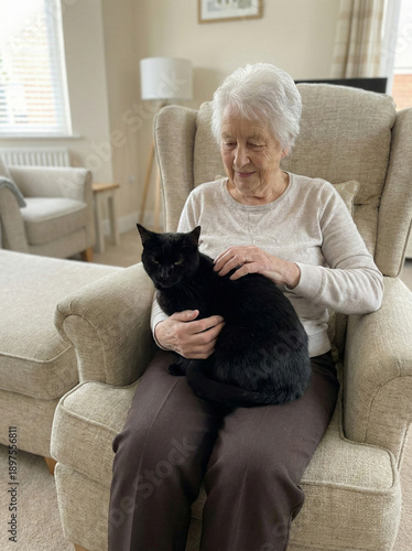 Affectionate Embrace: An elderly woman tenderly cradles a sleek black cat in her lap, sharing a moment of quiet companionship and love.