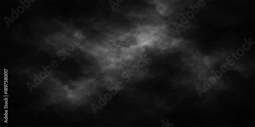 Dark storm clouds swirl in a black and white smoke texture under a moody night sky filled with abstract overcast light and stormy nature elements