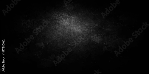 A dark and vintage black and white grunge background features a textured grey concrete wall surface with aged stone patterns and a rough smoky paper design for a blank wallpaper backdrop