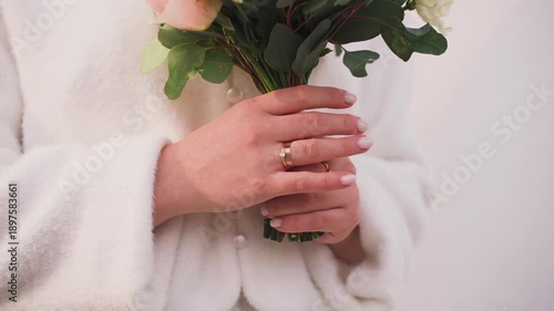 A young bride with a wedding bouquet in her hands