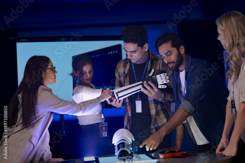 A startup team develops future medical technology. The diverse engineers test a new AI robotic prosthetic, an innovative solution for healthcare and digital transformation.