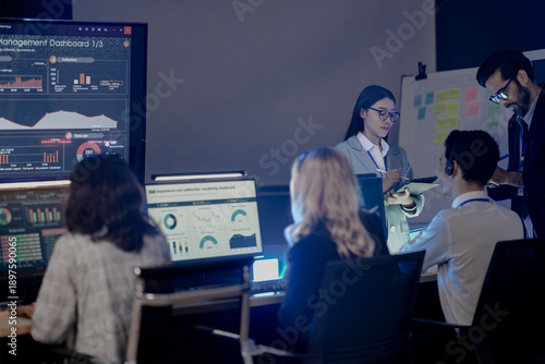 Future mission control synergy Diverse team leverages AI predictive insights interactive screens guide complex operations leader directs augmented human AI team achieve optimal results.