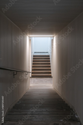 Steps Lead out of a Hallway Into a Bright Area at a Building in the Afternoon...