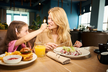 Child treats mother with french fries