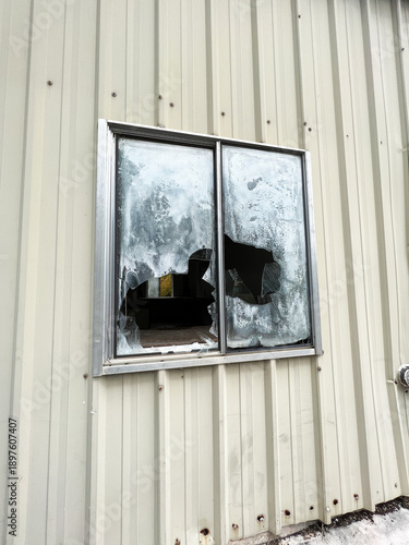 Broken out window of abandoned building.