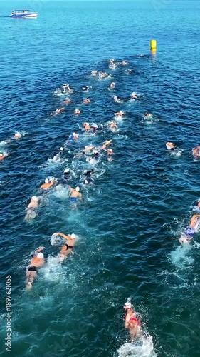 Vertical 4K Drone Shot of Open Sea Swimmers – People Swimming in Deep Blue Ocean (9:16)