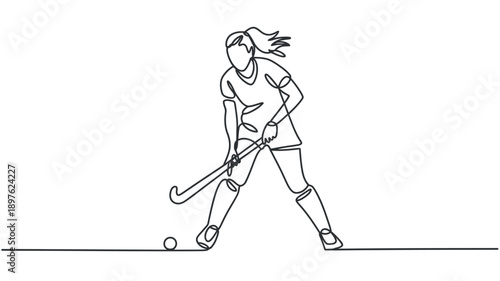 A female field hockey player in action, skillfully controlling the ball with her stick on the field.