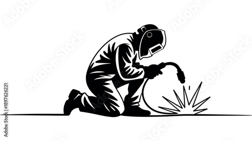 A welder kneeling down and welding a piece of metal with a welding torch.