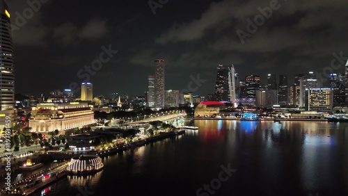 Aerial drone view of Singapore night light show with vibrant skyline and reflections