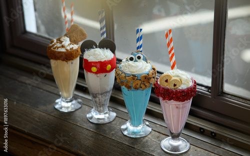Φωτογραφία Four different types of milkshakes with different toppings and straws