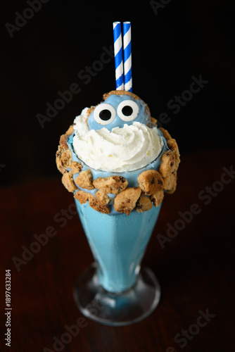 A blue drink with cookie crumbs and a blue cookie monster on top