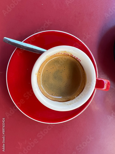Coffee in cup on red dramatic background.