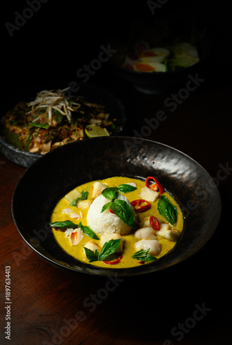 A bowl of food with rice and green curry