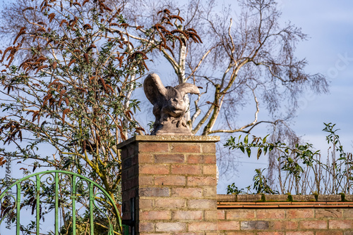 Stone gargoyles on brick gate posts