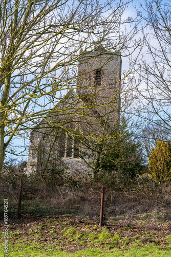Anglo Saxon church behind bare and leafless trees. Captured on a bright but cold winter day