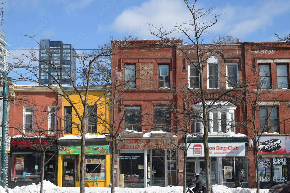 Fototapeta premium exterior building facades and shop signs on buildings from 419 to 411 Spadina Av, Toronto, winter