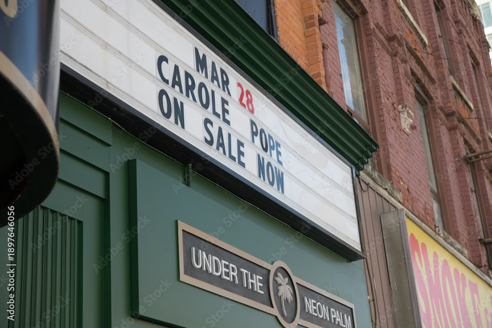 Obraz premium close-up of marquee sign with text (Mar 28, Carole Pope, On Sale Now) at El Mocambo, 464 Spadina Av, Toronto