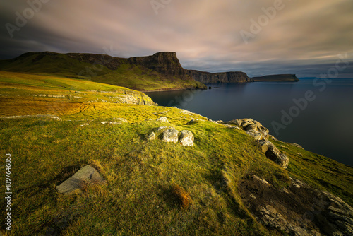 Wallpaper Mural Coastal landscape at Waterstein Head on the Isle of Skye, Scotland, with rugged cliffs, grassy foreground and calm sea under soft dramatic clouds, capturing the wild beauty of the Scottish coast Torontodigital.ca