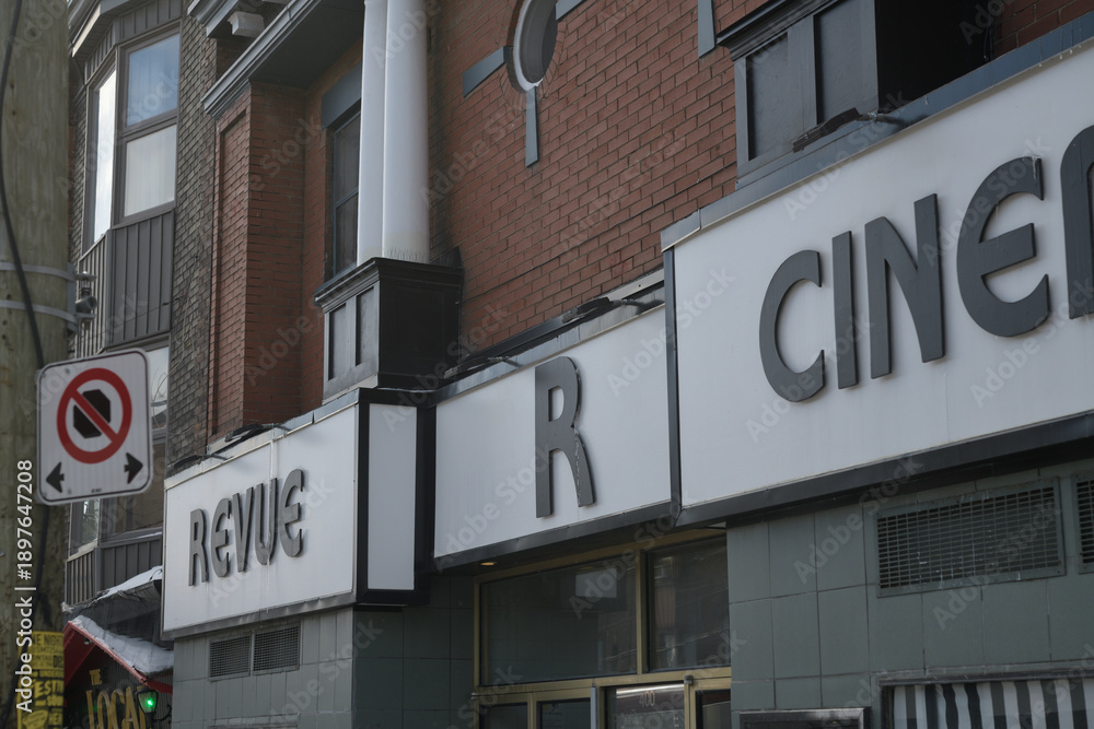 Obraz premium exterior building facade and detail of sign outside Revue Cinema, a movie theatre, located at 400 Roncesvalles Av, Toronto