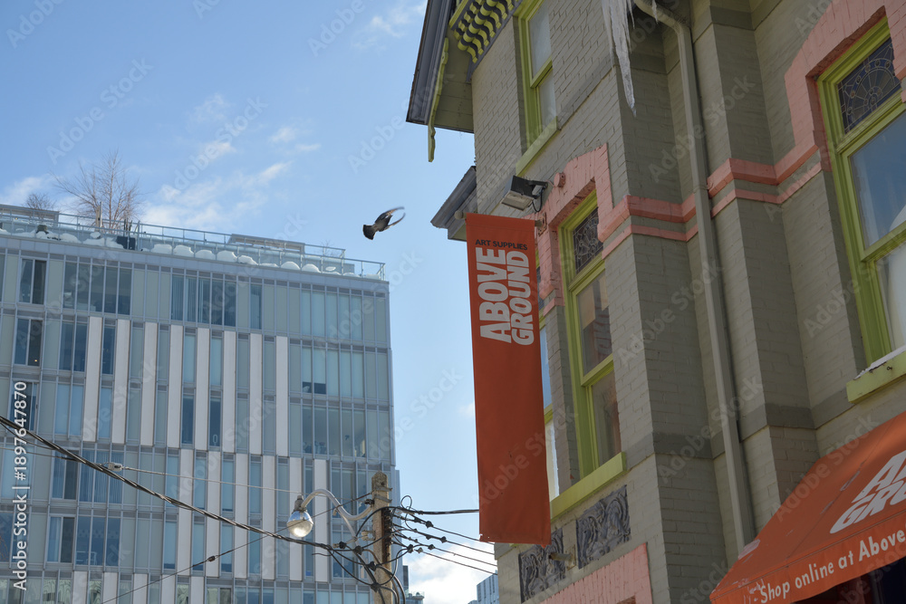 Obraz premium view of residence and projecting signs outside Above Ground Art Supplies at 74 McCaul St, Toronto