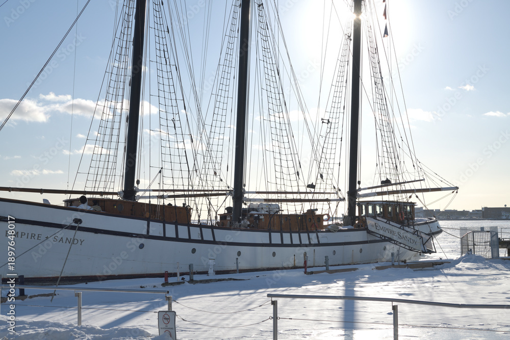 Fototapeta premium The Empire Sandy, a large passenger sailing ship, moored in Toronto Harbor in winter