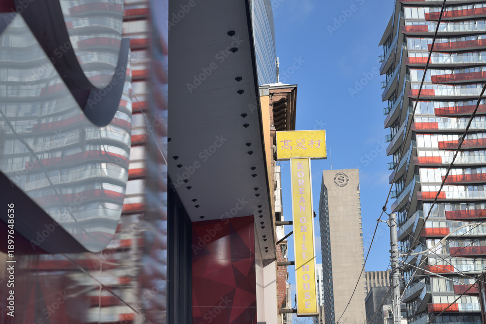 Fototapeta premium abstract view of (l-r) Scotiabank branch, Korean Grill House projecting sign (222, 214 Queen St W), Sheraton Centre, and a condo, in Toronto 