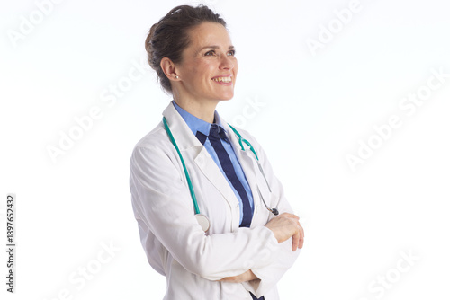 Slika na platnu A female healthcare professional in a white coat and stethoscope looks upwards with an optimistic smile, representing hope and visionary medical care