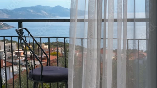 Wallpaper Mural White sheer curtains blowing in the wind revealing sea view. White sheer curtains fluttering in a gentle breeze, revealing a beautiful sunny balcony view of the sea, a coastal town Torontodigital.ca