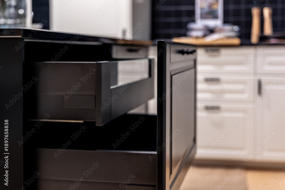 Fototapeta premium Matte black kitchen cabinet with open drawer. Dark aesthetic.