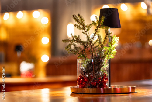 Christmas table decor with pine branches and red ornaments