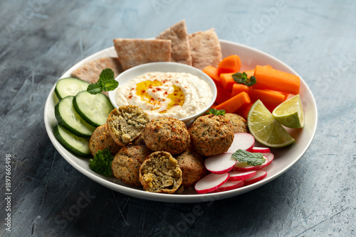 Falafel Plate Platter with hummus, vegetables and pita. Healthy food snack.