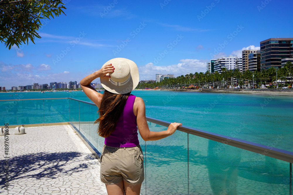 Fototapeta premium Holidays in Brazil. Young woman strolling on promendae in Maceio, Alagoas, Brazil.