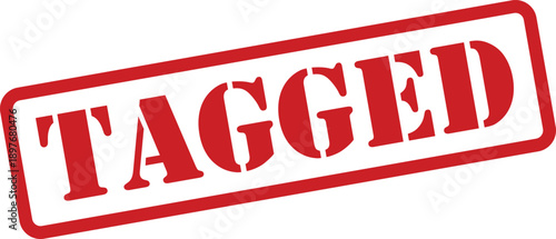 A distinctive red rubber stamp prominently featuring the word TAGGED at an angle on a clean white surface